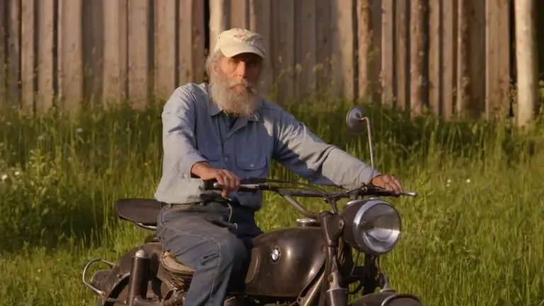 Burt from Burts Bees on a Motorcycle. A screenshot from Burts Buzz Documentary