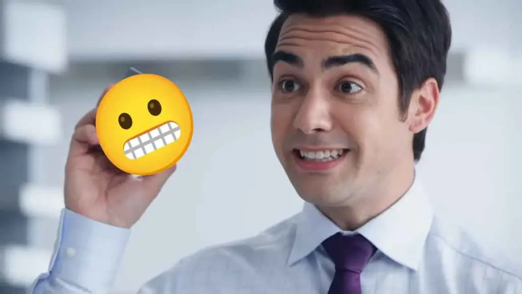 A man holds up an emoji